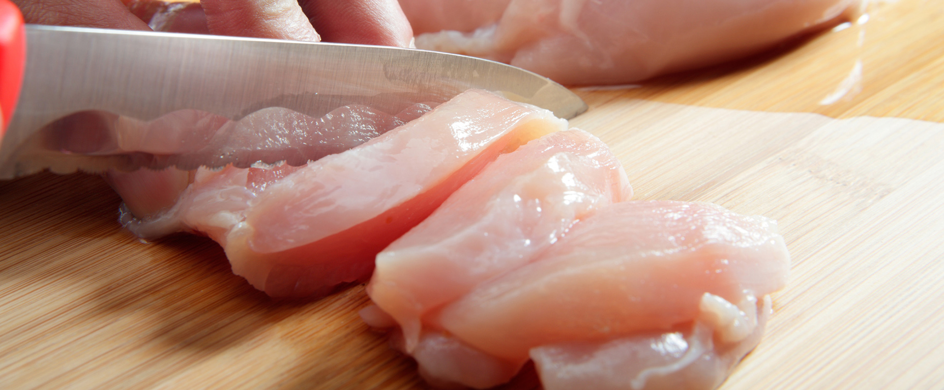 Raw chicken being sliced