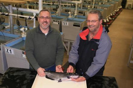Two researchers holding a catfish