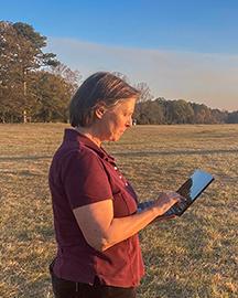Scientist monitoring real-time measurements of soil carbon, captured by the Mobile Inelastic Neutron Scattering scanning system. 