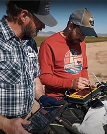 Two scientists looking at a soil map.