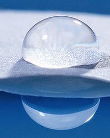 A drop of water on paper with water resistant starch-based coating.
