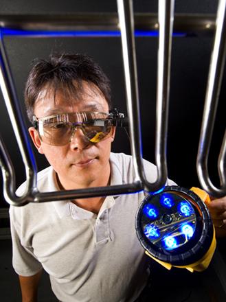 Biophysicist Moon Kim tests a portable imaging device 