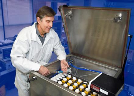 ARS chemical Engineer David Geveke measures new radio frequency (RF) equipment that he and his colleagues developed to kill Salmonella and E. coli in fresh eggs.